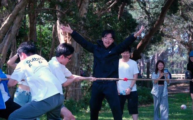 AWS UNSW members playing tug-of-war outdoors at Centennial Park