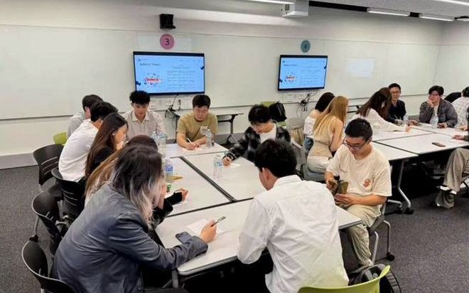 Students in small-group roundtable discussions with industry professionals