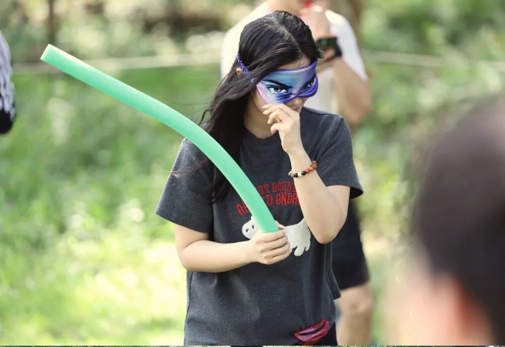 A blindfolded member playing a game at the AWS Sports Day